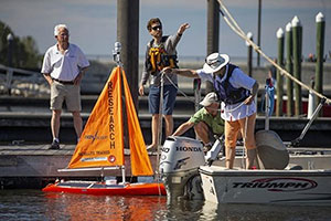 A Harbor Branch Oceanographic Institute autonomous research sailboat is placed on Lake Okeechobee